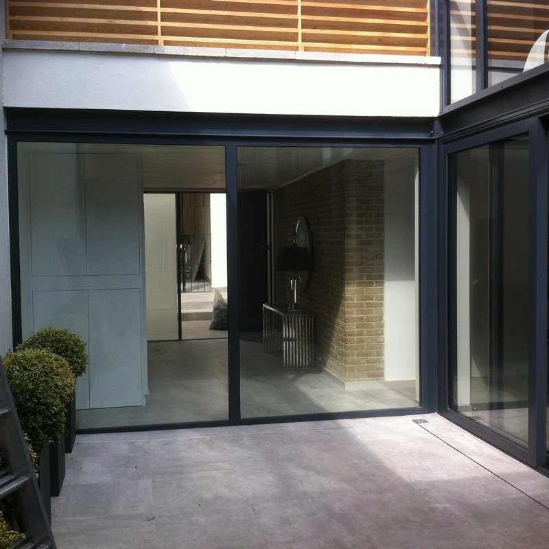 Floor-to-ceiling sliding doors opening to courtyard in Olney